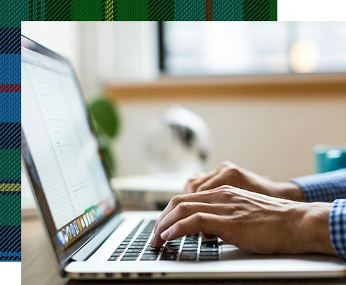 A person typing on a laptop computer.