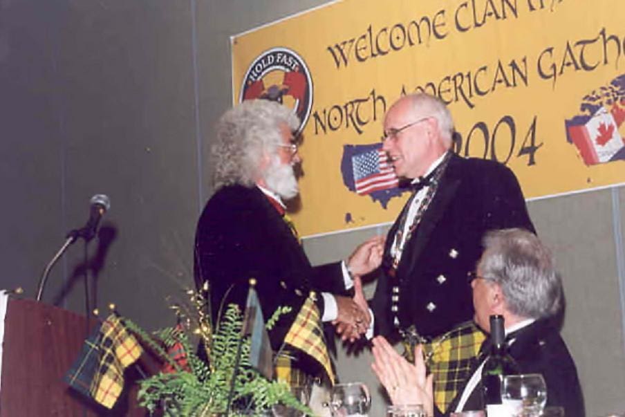 A man shaking hands with another person at an event.