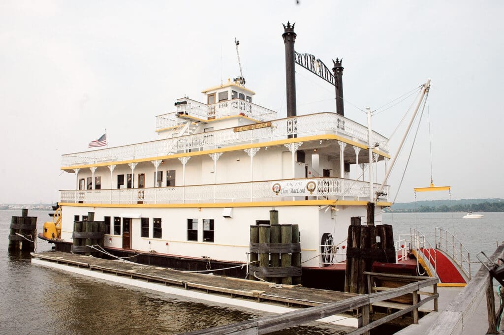 A large white boat docked at the dock.